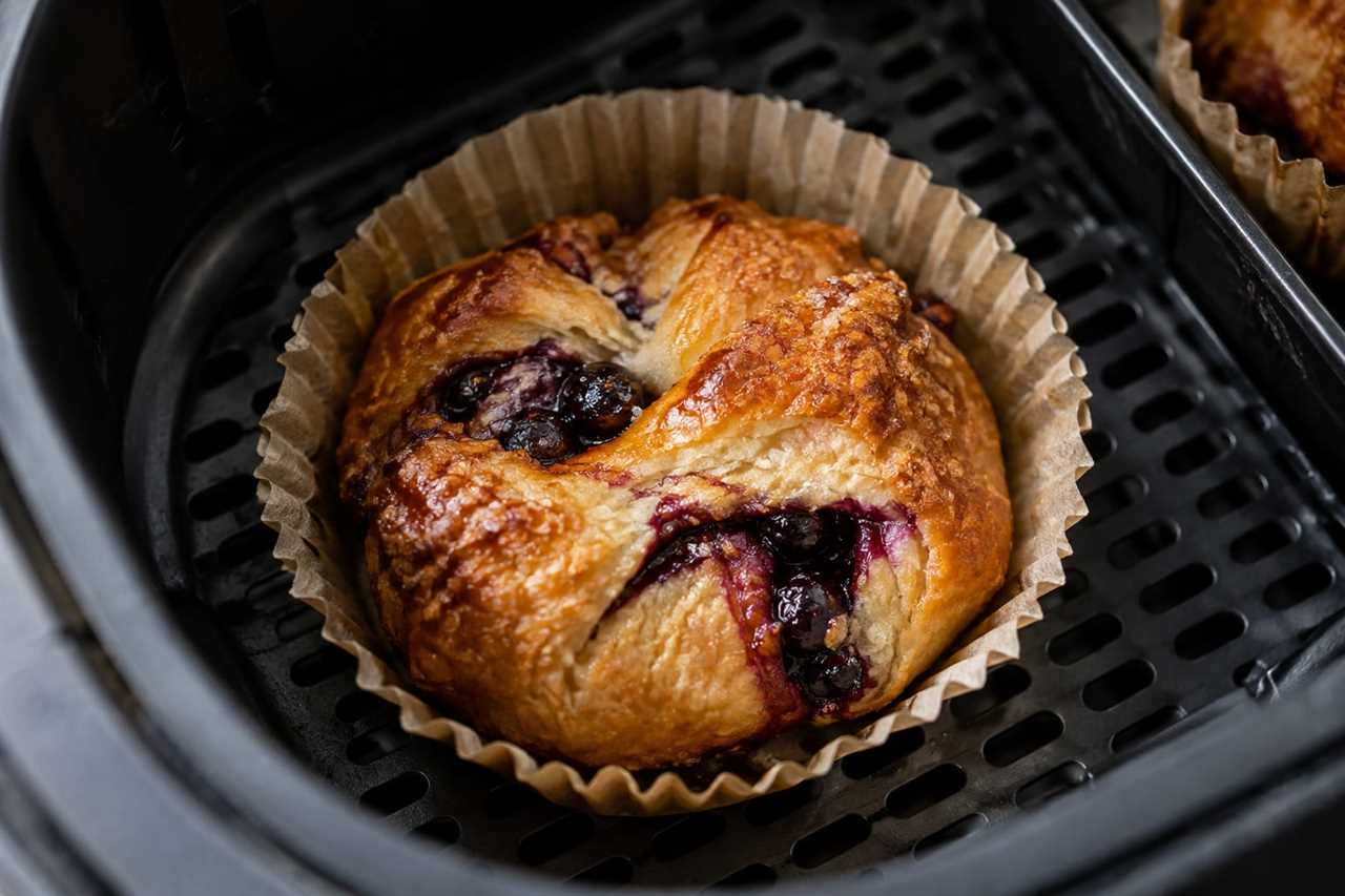 Blueberry cheesecake croissant warming in an air fryer